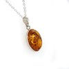  	Sterling Silver Oval Bezel Set Amber Pendant