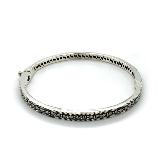  	Sterling Silver solid 4.5mm hinged Bangle set with marcasites. Inside diametre approx 56mm 